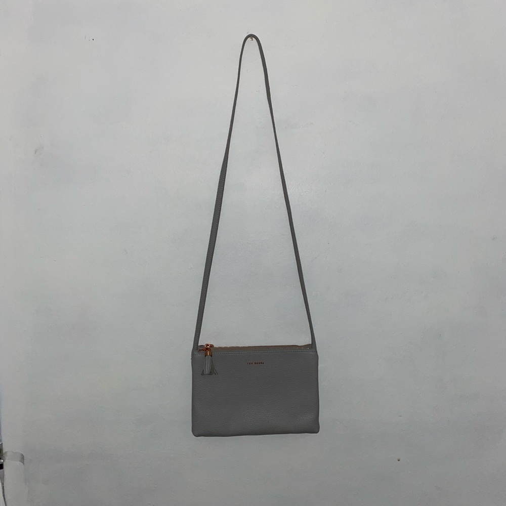 This gray Crossbody Ted Baker bag w gold detailing
